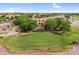 Aerial shot overlooking a golf course home nestled among mature trees and manicured grounds at 6145 E Snowdon St, Mesa, AZ 85215