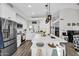 Bright kitchen featuring white cabinets, stainless steel appliances, and a large center island with seating at 6145 E Snowdon St, Mesa, AZ 85215