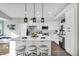 Modern kitchen with white cabinetry, a large island, pendant lighting, and stainless appliances at 6145 E Snowdon St, Mesa, AZ 85215