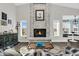 Inviting living room featuring a brick fireplace and ample natural light from two windows at 6145 E Snowdon St, Mesa, AZ 85215