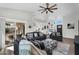 Bright and open living area with sliding glass doors to patio, and view of kitchen and entryway at 6145 E Snowdon St, Mesa, AZ 85215