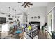 Spacious open-concept living room and kitchen with seating, piano, and lots of natural light at 6145 E Snowdon St, Mesa, AZ 85215