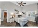 Cozy main bedroom offers natural light, a ceiling fan and warm decor at 6145 E Snowdon St, Mesa, AZ 85215