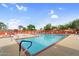 Inviting community pool with lounge chairs and clear blue water for relaxation and recreation at 6145 E Snowdon St, Mesa, AZ 85215