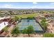 Overhead view of well-maintained community tennis courts surrounded by lush landscaping and residential homes at 6145 E Snowdon St, Mesa, AZ 85215
