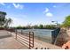 Outdoor tennis courts offer a sunny spot for recreation with desert landscaping, lighting, and perimeter fencing at 6145 E Snowdon St, Mesa, AZ 85215