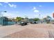 Well-maintained tennis courts with a shaded seating area and a golf cart nearby for easy transportation around the community at 6145 E Snowdon St, Mesa, AZ 85215