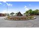 A desert-themed traffic circle offers a scenic welcome with unique art and colorful flowers at 6145 E Snowdon St, Mesa, AZ 85215