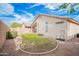 Exterior view of the backyard featuring block walls, a lush lawn, and the home at 636 E Redondo Dr, Gilbert, AZ 85296