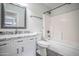 Well-lit bathroom features granite countertop, decorative mirror, tiled shower-over-tub, and gray flooring at 636 E Redondo Dr, Gilbert, AZ 85296