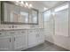 Bright bathroom features granite counters, double sinks, framed mirror, and a shower/tub at 636 E Redondo Dr, Gilbert, AZ 85296