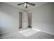 Carpeted bedroom includes a ceiling fan and closet with an open door for optimal storage at 636 E Redondo Dr, Gilbert, AZ 85296
