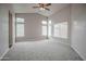 Bright bedroom with neutral walls, carpet flooring, ceiling fan, and multiple windows at 636 E Redondo Dr, Gilbert, AZ 85296