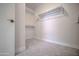 Walk-in closet with carpet flooring, shelving, and ample storage space at 636 E Redondo Dr, Gilbert, AZ 85296