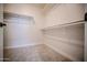 Spacious walk-in closet with carpet flooring and built-in shelving for easy organization at 636 E Redondo Dr, Gilbert, AZ 85296