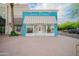 Exterior of Hale Studios with a blue and white facade and striped awning in Gilbert, Arizona at 636 E Redondo Dr, Gilbert, AZ 85296