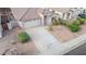 Aerial view of a well-kept single-story home with desert landscaping, large driveway and tile roof at 636 E Redondo Dr, Gilbert, AZ 85296