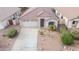 Aerial view of a single-story home featuring a two-car garage, neutral color scheme, and desert landscaping at 636 E Redondo Dr, Gilbert, AZ 85296