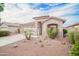 Beautifully landscaped home exterior with desert landscaping and a charming facade at 636 E Redondo Dr, Gilbert, AZ 85296
