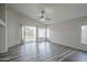 Bright living room boasts wood-look floors, vaulted ceiling, fan, and sliding glass doors to backyard at 636 E Redondo Dr, Gilbert, AZ 85296