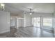 Living room with wood-look floors and a ceiling fan offers access to the backyard through sliding doors at 636 E Redondo Dr, Gilbert, AZ 85296