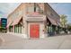 Exterior of Hale Centre Theatre with a red door and box office under striped awnings at 636 E Redondo Dr, Gilbert, AZ 85296