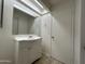 A bathroom featuring a vanity sink, mirror, towel rack and door at 6842 S 42Nd Pl, Phoenix, AZ 85042
