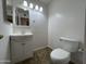 Bathroom with a vanity sink, framed mirror, toilet, towel ring, and modern lighting at 6842 S 42Nd Pl, Phoenix, AZ 85042