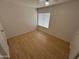 Neutral bedroom with wood floors and a window with blinds at 6842 S 42Nd Pl, Phoenix, AZ 85042