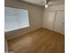 Bedroom with wood floors, a window, and a closet with sliding doors at 6842 S 42Nd Pl, Phoenix, AZ 85042