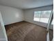 A spacious bedroom with carpet flooring and a window at 6842 S 42Nd Pl, Phoenix, AZ 85042