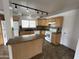 Bright kitchen featuring light wood cabinets, an island, and modern appliances at 6842 S 42Nd Pl, Phoenix, AZ 85042