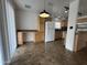 Open kitchen with light wood cabinetry, white refrigerator, and built-in desk area at 6842 S 42Nd Pl, Phoenix, AZ 85042