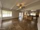 Open living room with tile flooring, ceiling fan, and seamless access to the kitchen at 6842 S 42Nd Pl, Phoenix, AZ 85042