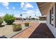Landscaped front yard with brick-paved patio, mature bushes, and beautiful greenery enhances this home's curb appeal at 6923 E Hubbell St, Scottsdale, AZ 85257