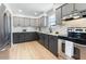 Modern kitchen featuring gray cabinets, stainless steel appliances, and bright, natural lighting at 6923 E Hubbell St, Scottsdale, AZ 85257