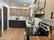 Updated kitchen featuring granite countertops, modern backsplash, stainless steel appliances, and wood flooring at 6923 E Hubbell St, Scottsdale, AZ 85257