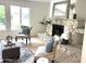 Cozy living room showcasing a stone fireplace, plush seating, and ample natural light at 6923 E Hubbell St, Scottsdale, AZ 85257