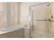 Bathroom features a soaking tub, and a glass-enclosed shower at 710 W Cherrywood Dr, Chandler, AZ 85248