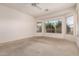 Well-lit bedroom showcasing bright windows and carpet flooring at 710 W Cherrywood Dr, Chandler, AZ 85248