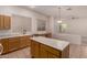 Bright kitchen featuring tile flooring, wood cabinets, an island, and stainless steel dishwasher at 710 W Cherrywood Dr, Chandler, AZ 85248