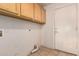 Functional laundry area with cabinets and access to the exterior at 710 W Cherrywood Dr, Chandler, AZ 85248