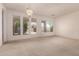 Well-lit living room with carpet, chandelier, and large windows offering an abundance of natural light at 710 W Cherrywood Dr, Chandler, AZ 85248