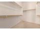 Bright walk-in closet with built-in shelving and carpet flooring at 710 W Cherrywood Dr, Chandler, AZ 85248