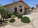 Well-manicured backyard featuring lush landscaping and a covered patio perfect for outdoor entertaining at 7724 W Topeka W Dr, Glendale, AZ 85308