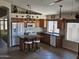 Bright kitchen featuring wooden cabinets, a central island with seating, and modern appliances under pendant lighting at 7724 W Topeka W Dr, Glendale, AZ 85308