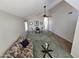 Open living area with high ceilings, plush green carpet, and a view of the adjacent dining space at 7724 W Topeka W Dr, Glendale, AZ 85308