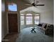 Comfortable living room with large windows, a ceiling fan, and a green carpet at 7724 W Topeka W Dr, Glendale, AZ 85308