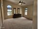 Main bedroom with vaulted ceiling, neutral carpet and furniture with views of the pool at 7724 W Topeka W Dr, Glendale, AZ 85308