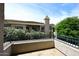 Enjoy the view from this home's balcony, framed by mature trees and showcasing the building's architecture at 8180 E Shea Blvd # 1075, Scottsdale, AZ 85260